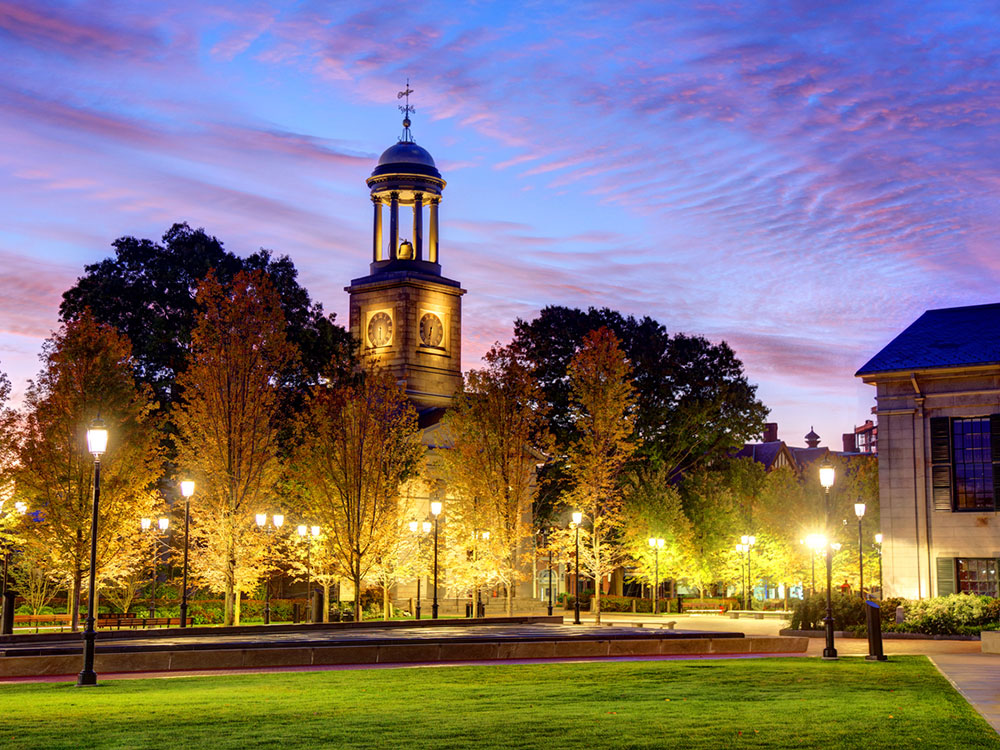 A bell tower lit up at dusk