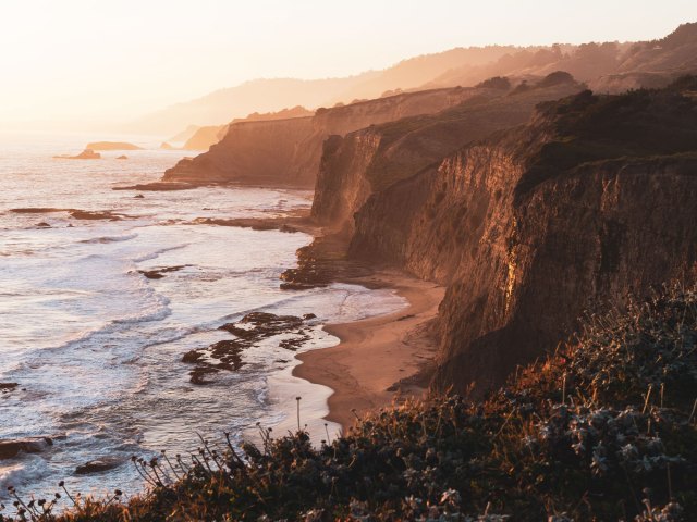 Tall seacliffs along California coast at sunset, seen from above