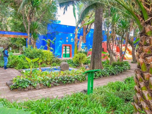 View of the Blue House across lush courtyard in Mexico City