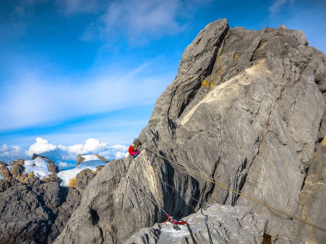 Climbing ropes on steep rocky slopes of Puncak Jaya