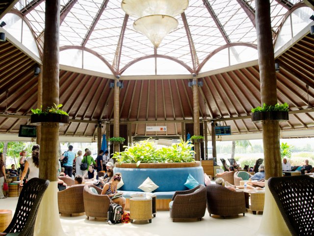 Passengers waiting in open-air terminal of Samui Airport in Thailand