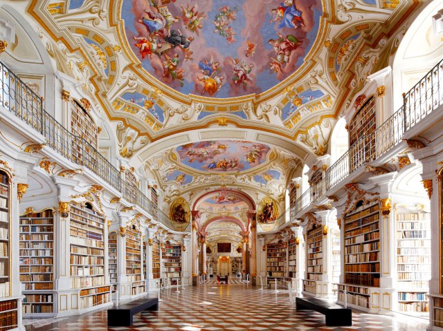 Fresco ceilings and rows of books inside the Admont Abbey Library in Austria