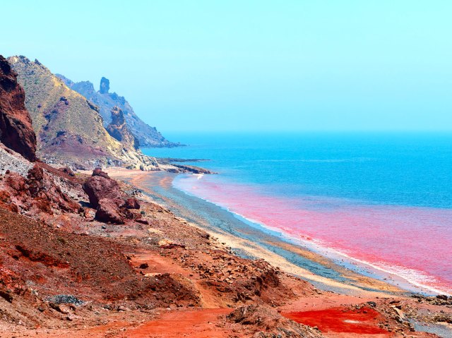 Multi-colored coast and waters of Rainbow Island in Iran, seen from above