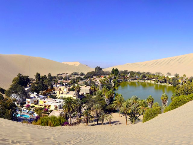 Overview of Huacachina, Peru, surrounded by sand dunes