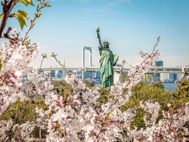 Replica Statue of Liberty surrounded by cherry blossoms in Tokyo, Japan