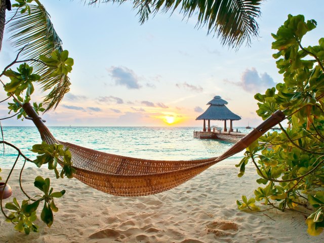 Hammock on beach in the Maldives at sunset