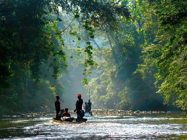 People on river through the Baudó Mountains of Colombia