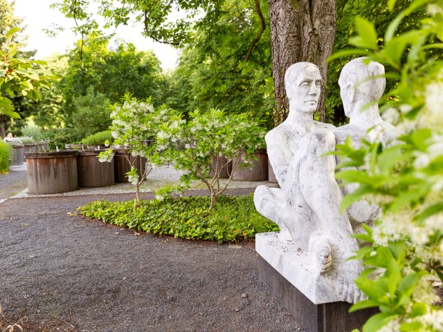 Statue and gardens at Botanischer Garten der Universität Leipzig in Germany
