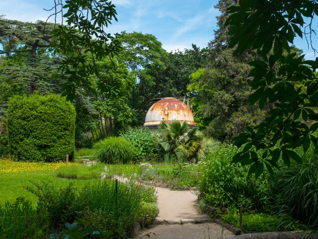 Domed structure surrounded by pathways and greenery at Jardin des Plantes Montpellier in France