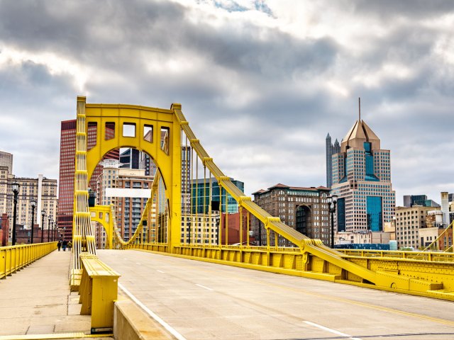 Yellow bridge leading to skyscrapers in downtown Pittsburgh, Pennsylvania 