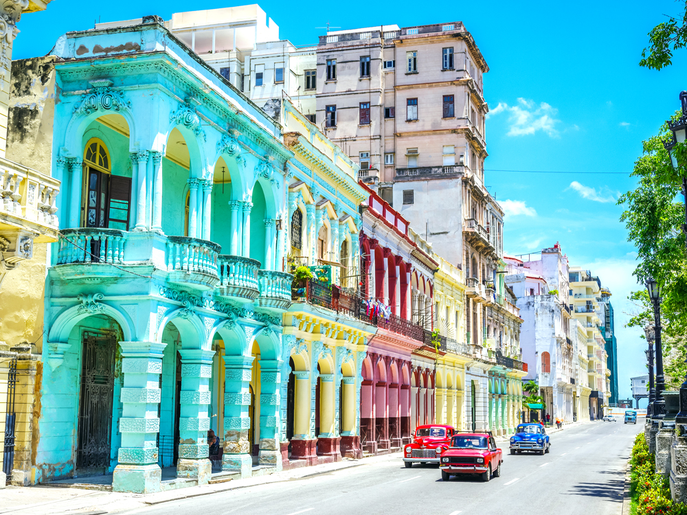 Brightly colored buildings and vintage automobiles in Havana, Cuba