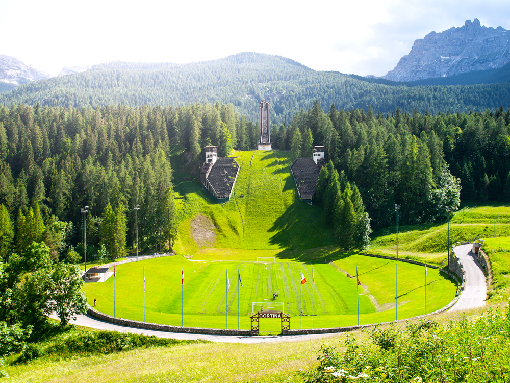 Abandoned Trampolino Olimpico Italia (Italian Olympic Ski Jump) overgrown with grass in Cortina d’Ampezzo in the Dolomites